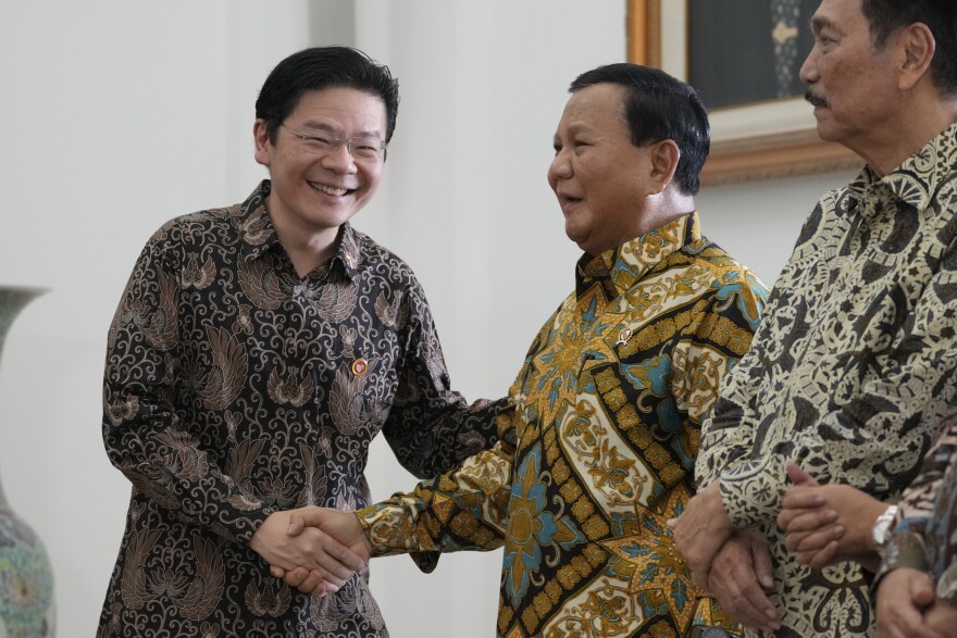 Indonesian Defense Minister and president-elect Prabowo Subianto, right, shakes hands with Singapore's Deputy Prime Minister and Finance Minister Lawrence Wong during their meeting at Bogor Presidential Palace in Bogor, Indonesia, Monday, April 29, 2024. (AP Photo/Achmad Ibrahim)