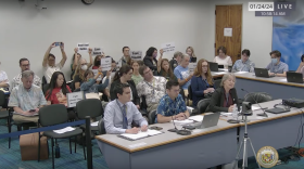 State Attorney General Anne Lopez, seated in front on the right, discusses the funding needed for the state's legal defense during a committee meeting. Sen. Donovan Dela Cruz called a brief recess after attendees held up climate-action signs. (Jan. 24, 2024)