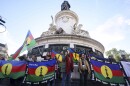 Demonstrators hold Kanak and Socialist National Liberation Front (FLNKS) flags during a gathering in Paris, Thursday May 16, 2024. Violence raged across New Caledonia for the third consecutive day Thursday, hours after France imposed a state of emergency in the French Pacific territory, boosting security forces' powers to quell unrest in the archipelago that has long sought independence. (AP Photo/Thomas Padilla)