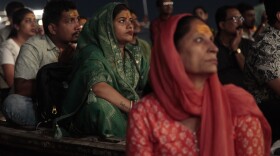 Worshippers and tourists sit on boats facing the bank of the Ganges River in the holy Hindu city of Varanasi to watch the Ganga Aarti, a ritual of devotion to the venerated river. Hindu priests wave fire as the sun sets, ring bells and tap on drums. Thousands watch, clap and chant along from boats crammed in the water.