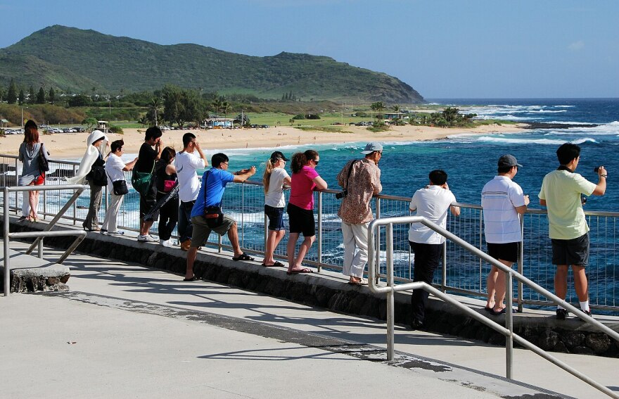 FILE - Tourists at the Hālona Blowhole Lookout on Oʻahu.