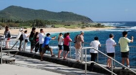 FILE - Tourists at the Hālona Blowhole Lookout on Oʻahu.