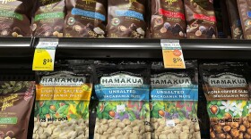 Packages of macadamia nuts are displayed on store shelves on Friday, April 26, 2024, in Honolulu. For decades, tourists to Hawaiʻi have brought home gift boxes of the islands' famous chocolate-covered macadamia nuts for friends and family. (AP Photo/Audrey McAvoy)