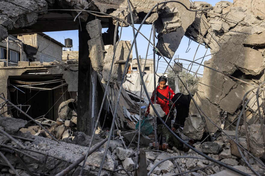 Amid the rubble of a collapsed building in Rafah, in southern Gaza, a woman and a girl search for items on April 24, following reported Israeli airstrikes overnight.