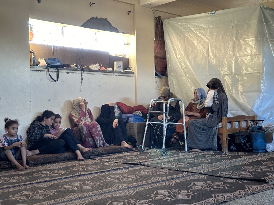 Abu Issa family members sit in a classroom of a bombed-out school, their new temporary home, in Khan Younis on May 24.