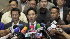 Pita Limjaroenrat, the leader of Move Forward Party, center, and Leader of Pheu Thai party Chonlanan Srikaew ,left, talks reporter after meeting in Bangkok, Thailand, Monday, July 17, 2023. The top candidate to become Thailand's next prime minister, Move Forward Party leader Pita Limjaroenrat, who was rebuffed last week by an initial vote of Parliament, declared Monday he will remain a candidate for a second round of ballot but acknowledges he may have to make way for a political ally if he cannot attract substantially more support.