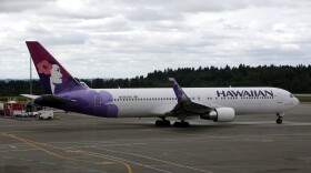 FILE - In this June 7, 2010 file photo an Hawaiian Airlines plane is shown at Seattle-Tacoma International Airport in Seattle. (AP Photo/Ted S. Warren, File)