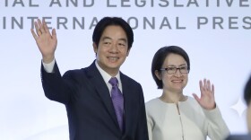 Taiwan Vice President and Democratic Progressive Party presidential candidate William Lai, left, and his running mate Hsiao Bi-khim wave to the press during an international press conference in Taipei, Taiwan, Tuesday, Jan. 9, 2024. Taiwan will hold its presidential election on Jan. 13. (AP Photo/Chiang Ying-ying)