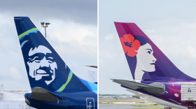 Alaska Airlines and Hawaiian Airlines plane tails side by side