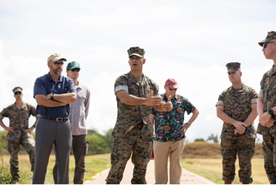 U.S. Marine Corps Col. Speros Koumparakis, commanding officer, Marine Corps Base Hawaiʻi, discusses concerns from community members with elected officials during a tour of Puuloa Range Training Facility, Hawaiʻi, April 17, 2023.