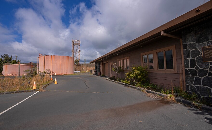 The Okamura Building on the right, with the USGS instrument tower that will remain and two large water tanks that will be removed. (Jan. 26, 2024)