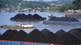 Barges fully loaded with coal are anchored on Mahakam river in Samarinda, East Kalimantan, Indonesia, Monday, Dec. 19, 2022.