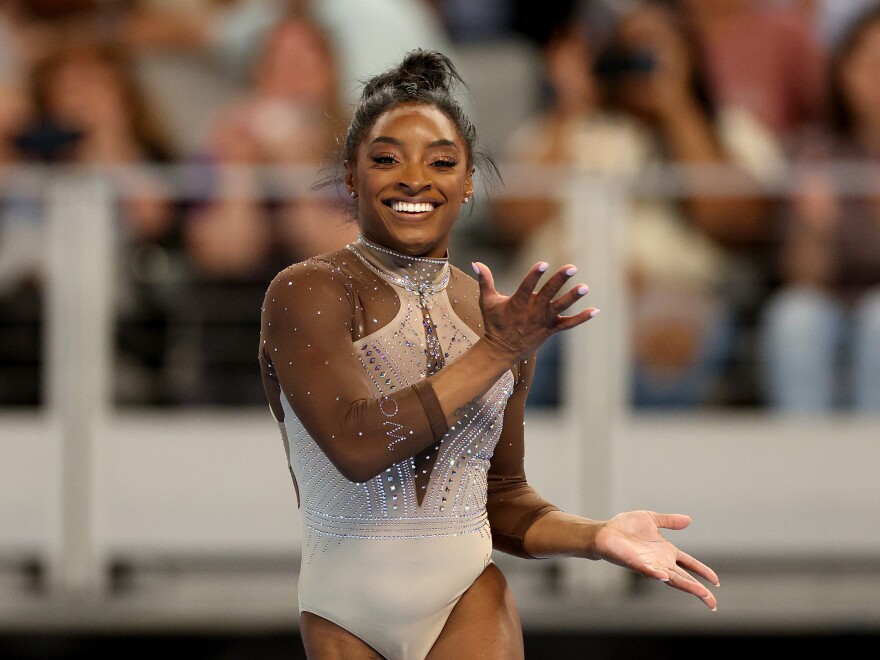 Simone Biles smiles during her floor exercise routine at the U.S. Gymnastics Championships on Sunday. 