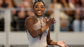 Simone Biles smiles during her floor exercise routine at the U.S. Gymnastics Championships on Sunday. 