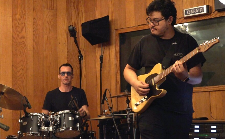 Beck Millan (drums) and Hiʻi Copp (guitar) accompany Evan Khay in a private recording session.