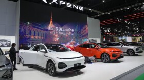 Visitors look at XPENG's electric vehicles during the 45th Bangkok Motor Show in Nonthaburi, Thailand, Tuesday, March 26, 2024. (AP Photo/Sakchai Lalit)