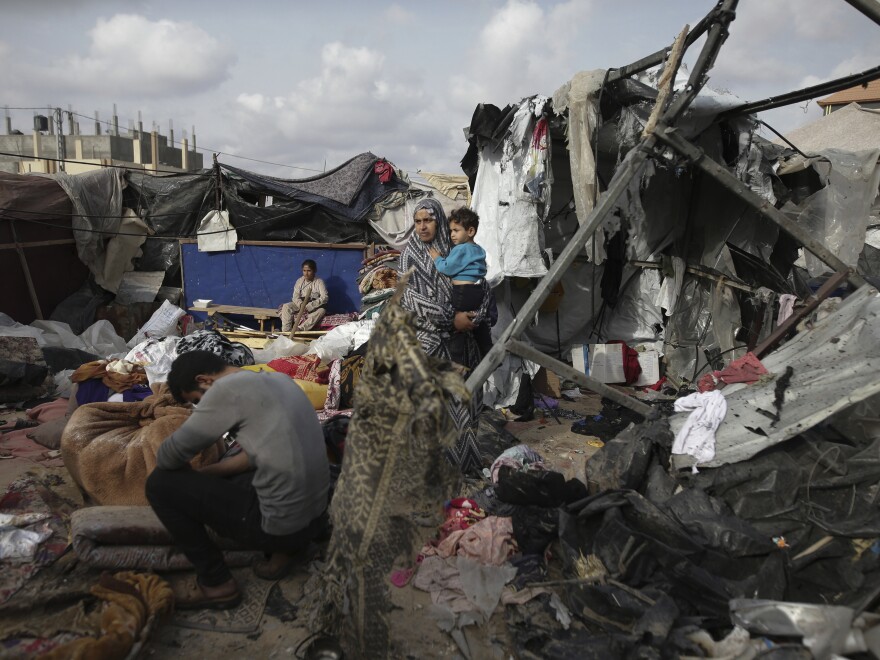 Displaced Palestinians inspect their tents destroyed by Israel's bombardment, adjunct to an UNRWA facility west of Rafah city, Gaza Strip, Tuesday, May 28, 2024.