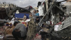 Displaced Palestinians inspect their tents destroyed by Israel's bombardment, adjunct to an UNRWA facility west of Rafah city, Gaza Strip, Tuesday, May 28, 2024.