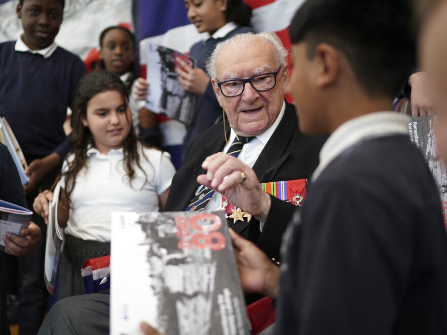 D-Day veteran and Ambassador for the British Normandy Memorial Ken Hay, 98, who served with the 4th Dorset Regiment, speaks to children during a visit to Rush Green Primary School in Dagenham, England, on Monday, May 20, 2024, ahead of the 80th anniversary of the D-Day landings.