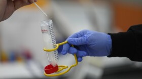 FILE - Passengers disembarking from international flights take anonymous COVID tests for study purposes at Newark Liberty International Airport in Newark, N.J., Wednesday, Jan. 4, 2023. (AP Photo/Seth Wenig)