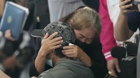 FILE - A relative hugs a Thai overseas worker who was evacuated from Israel, as he and others arrived at Suvarnabhumi International Airport in Samut Prakarn Province, Thailand, on Oct. 12, 2023. Since Hamas attacks on Israel nearly a month ago, more than 7,000 of some 30,000 Thais working in Israel have returned home on government evacuation flights. Some were abducted by Hamas fighters, while others are still missing, and a few dozens are confirmed dead.