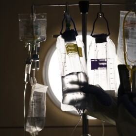 FILE - A nurse checks on IV fluids while talking to a COVID-19 patient in Los Angeles, Dec. 13, 2021. (AP Photo/Jae C. Hong, File)