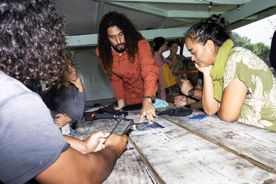 Dr. Cliff Kapono talks with members of Vai Ara O Teahupoʻo including Cindy Otcenasek (right). 