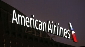 The NAACP is calling on American Airlines to provide an update on the pending investigations involving passengers and claims of racial discrimination. Here, the American Airlines logo stands atop the American Airlines Center on Dec. 19, 2017, in Dallas.