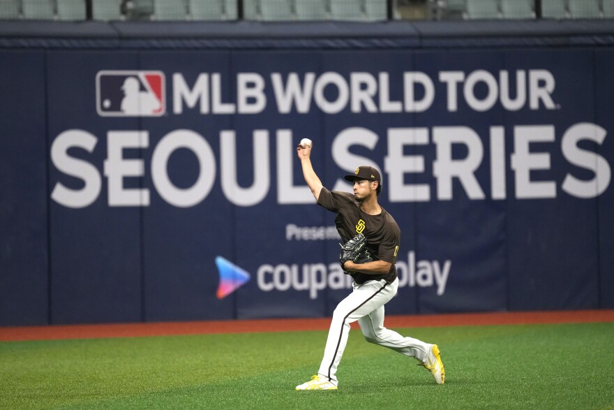 San Diego Padres' pitcher Yu Darvish warms up during a baseball workout at the Gocheok Sky Dome in Seoul, South Korea, Tuesday, March 19, 2024. Major League Baseball's season-opening games between the Los Angeles Dodgers and San Diego Padres in Seoul will be the first MLB games held in the baseball-loving nation. (AP Photo/Lee Jin-man)