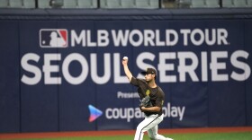 San Diego Padres' pitcher Yu Darvish warms up during a baseball workout at the Gocheok Sky Dome in Seoul, South Korea, Tuesday, March 19, 2024. Major League Baseball's season-opening games between the Los Angeles Dodgers and San Diego Padres in Seoul will be the first MLB games held in the baseball-loving nation. (AP Photo/Lee Jin-man)