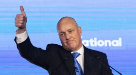 New Zealand National Party leader and Prime Minister-elect Christopher Luxon gestures to supporters at a party event in Auckland, Saturday, Oct. 14, 2023, following a general election. (AP Photo/Brett Phibbs)