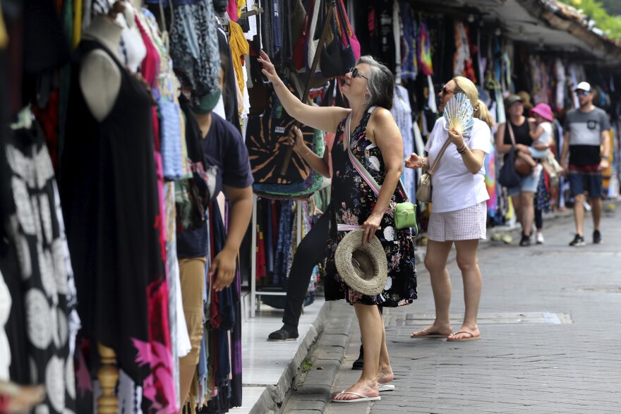 Foreign tourists shop for souvenirs in Bali, Indonesia on Saturday, Nov. 12, 2022.