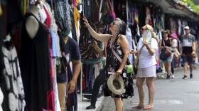 Foreign tourists shop for souvenirs in Bali, Indonesia on Saturday, Nov. 12, 2022.