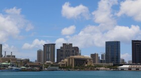 A view of Honolulu with Aloha Tower Marketplace on the left, the Prince Kūhiō Federal Building toward the front, and Kakaʻako on the right.