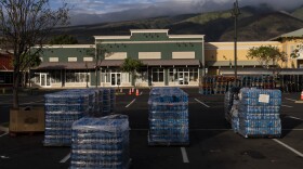 Bottled water is stacked at a food and supply distribution center in Lāhainā, Hawaiʻi, Tuesday, Aug. 22, 2023, following a devastating wildfire.