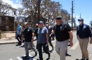 FILE - Gov. Josh Green, FEMA Administrator Deanne Criswell and Region 9 Administrator Bob Fenton walk through Lahaina just days after the fires swept through the town.