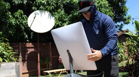 Michael Shiffer, CEO of nonprofit Red Lightning, installs a Starlink dish in Kaʻanapali.