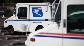 U.S. Postal Service mail vehicles sit in a parking lot at a mail distribution center on February 18, 2015 in San Francisco, Calif.