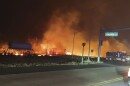 This photo provided by County of Maui shows fire and smoke filling the sky from wildfires on the intersection at Hokiokio Place and Lahaina Bypass in Maui, Hawaiʻi on Tuesday, Aug. 8, 2023. Wildfires in Hawaiʻi fanned by strong winds burned multiple structures in areas including historic Lahaina town, forcing evacuations and closing schools in several communities Wednesday, and rescuers pulled a dozen people escaping smoke and flames from the ocean.