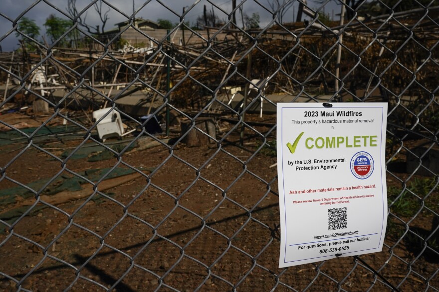 A flyer noting a property has undergone hazardous material removal is seen, Wednesday, Dec. 6, 2023, in Lahaina, Hawaiʻi. (AP Photo/Lindsey Wasson)