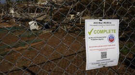 A flyer noting a property has undergone hazardous material removal is seen, Wednesday, Dec. 6, 2023, in Lahaina, Hawaiʻi. (AP Photo/Lindsey Wasson)