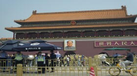 Police officers watch over Tiananmen Gate on Tuesday in Beijing. As Beijing's toughened political stance effectively extinguished any large-scale commemorations within its borders, overseas commemorative events have grown increasingly crucial for preserving memories of the Tiananmen crackdown.