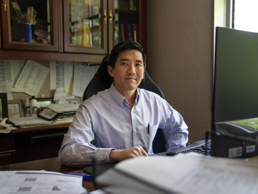 Dr. Jonathan Poon sits in his office at the Medical Center of Elberton.