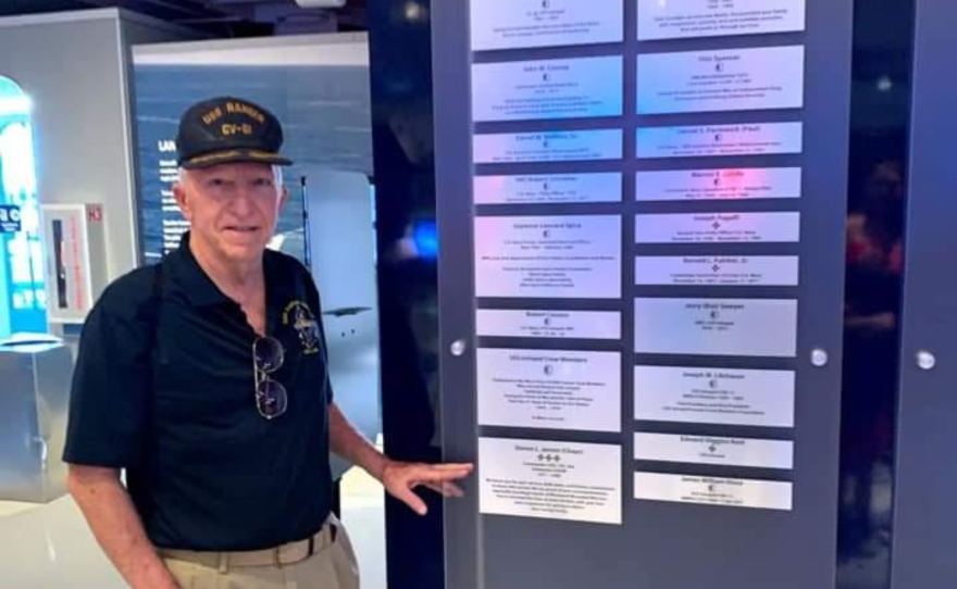 Retired Navy Chaplain Steven Jensen displays his plaque of honor at the Intrepid Museum's Honor Wall in New York City.