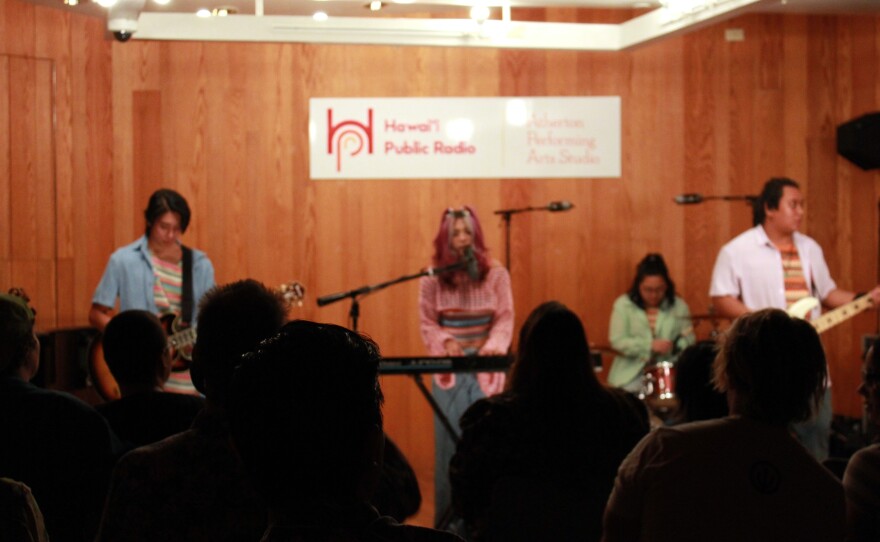 Concertgoers listen to Kennedy Taylor and The Electric Pancakes.