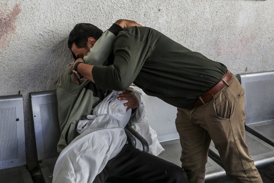 Ahmed Barhoum, displaced and now in Rafah, holds the body of his daughter Alaa, 5, at a morgue on April 20. Israeli airstrikes the night before killed the child, her mother and seven other people, most of them children sheltering in a home in Rafah.