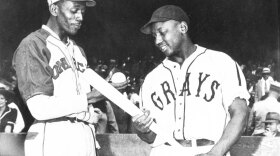 Satchel Paige of the Monarchs talks with Josh Gibson of the Homestead Grays before a game in Kansas City in 1941.