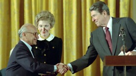 10/17/1988 President Reagan and Nancy Reagan in the East Room congratulating Milton Friedman receiving the Presidential Medal of Freedom.