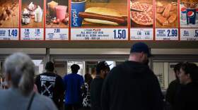 Customers wait in line at a Costco food court in Hawthorne, California.  