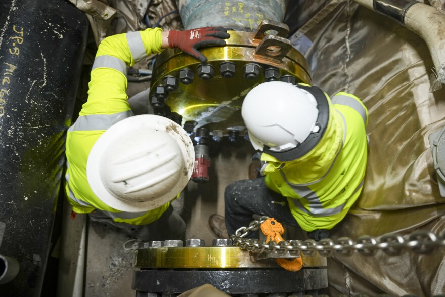 Personnel in support of Joint Task Force-Red Hill tighten bolts on air gap flanges on pipelines disconnecting the Underground Pumphouse at the Red Hill Bulk Fuel Storage Facility on March 13, 2024. Air gaps were created when crews removed sections of pipes to disconnect Red Hill from the Underground Pump House.